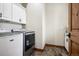 Bright laundry room featuring a washer, dryer, cabinetry and tile flooring at 5261 Sedona Dr, Parker, CO 80134