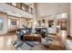 Open-concept living room featuring hardwood floors, a stone fireplace, and access to the kitchen at 5261 Sedona Dr, Parker, CO 80134