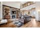Open-concept living room featuring a stone fireplace, hardwood floors, and a view of the upstairs loft at 5261 Sedona Dr, Parker, CO 80134