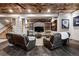 Basement living room features wood ceiling, stone accent wall, and comfortable seating at 5261 Sedona Dr, Parker, CO 80134