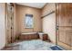 Mud room with stone floors, built-in bench seating, coat hooks, and natural light at 5261 Sedona Dr, Parker, CO 80134
