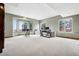 Spacious office with large windows, neutral carpet, and desk, offering views and ample workspace at 5261 Sedona Dr, Parker, CO 80134