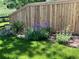 Purple irises and other flowers by fence at 8952 Sunset Ridge Ct, Highlands Ranch, CO 80126