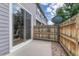 Private back patio with sliding glass doors and a wooden privacy fence at 17225 Lark Water Ln # C, Parker, CO 80134