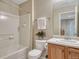 Cozy bathroom with oak cabinets, white tile, and neutral paint at 17225 Lark Water Ln # C, Parker, CO 80134