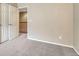 Neutral carpeted bedroom featuring warm paint, and an open doorway at 17225 Lark Water Ln # C, Parker, CO 80134