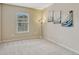 Bright carpeted bedroom featuring warm paint, wall art, and a sunny window at 17225 Lark Water Ln # C, Parker, CO 80134