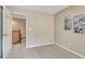 Neutral carpeted bedroom featuring warm paint, wall art, and an open doorway at 17225 Lark Water Ln # C, Parker, CO 80134