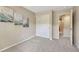 Neutral carpeted bedroom featuring warm paint, wall art, and a closet at 17225 Lark Water Ln # C, Parker, CO 80134