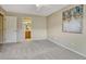 Bright bedroom with light-colored carpet, wall decor, and an open door to the bathroom at 17225 Lark Water Ln # C, Parker, CO 80134