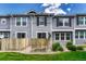 Townhome exterior with well-kept lawn and privacy-fenced patio areas at 17225 Lark Water Ln # C, Parker, CO 80134