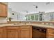 A bright kitchen offers wood cabinetry, stainless appliances, and a view into the living room at 17225 Lark Water Ln # C, Parker, CO 80134