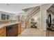 Kitchen boasts stainless dishwasher and a view of the staircase leading to the upper level at 17225 Lark Water Ln # C, Parker, CO 80134