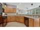 Open kitchen features wood cabinetry, stainless appliances, and access to the living room at 17225 Lark Water Ln # C, Parker, CO 80134