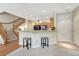 Kitchen with breakfast bar, wood cabinets, and black appliances at 17225 Lark Water Ln # C, Parker, CO 80134