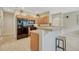 Open kitchen featuring wood cabinetry, breakfast bar, and modern black appliances at 17225 Lark Water Ln # C, Parker, CO 80134