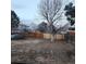 Large backyard with wooden fence providing privacy, shade tree, and lots of room for outdoor activities at 17421 E Grand Ave, Aurora, CO 80015