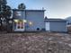 Exterior view of the home showcasing the back with patio doors and the nice gray siding at 17421 E Grand Ave, Aurora, CO 80015