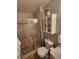 Bathroom features a glass-enclosed shower, toilet, and cabinet, offering functionality and storage at 17421 E Grand Ave, Aurora, CO 80015