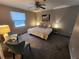 Inviting bedroom with a cozy bed, soft lighting, and carpet flooring at 17421 E Grand Ave, Aurora, CO 80015