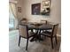 Dining room with a round table, four chairs, and natural light from a glass door at 17421 E Grand Ave, Aurora, CO 80015
