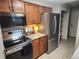Modern kitchen with stainless steel appliances, granite countertops, and wood cabinets at 17421 E Grand Ave, Aurora, CO 80015