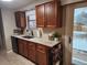 Functional kitchen with a granite countertop, dark wooden cabinetry, and ample counter space at 17421 E Grand Ave, Aurora, CO 80015