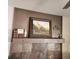 Close-up of the fireplace mantel, featuring decorative art and tile surround at 17421 E Grand Ave, Aurora, CO 80015