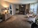 Spacious living room with a stone fireplace, neutral color palette and plush carpet at 17421 E Grand Ave, Aurora, CO 80015