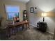 Functional home office with a wooden desk, chair, and shelving, perfect for remote work at 17421 E Grand Ave, Aurora, CO 80015