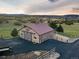 Aerial view of a rustic barn featuring an asphalt driveway and scenic views in a rural setting at 3080 Big Bear Dr, Sedalia, CO 80135