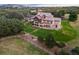 Aerial view of beautiful home featuring expansive lawn, patios, landscaping, and a hot tub at 3080 Big Bear Dr, Sedalia, CO 80135