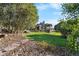 A sprawling backyard featuring lush greenery, trees, and stone pathways create a serene outdoor space at 3080 Big Bear Dr, Sedalia, CO 80135