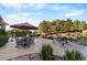 Backyard stone patio with furniture for outdoor dining and relaxing under an umbrella at 3080 Big Bear Dr, Sedalia, CO 80135