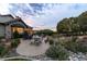 Backyard patio with stone details, landscaping, furniture, and serene views at 3080 Big Bear Dr, Sedalia, CO 80135