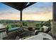 Covered balcony with comfortable seating and expansive mountain views at 3080 Big Bear Dr, Sedalia, CO 80135