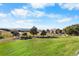 Barn with a metal roof in a sprawling grassy field with trees, mountains and a fence at 3080 Big Bear Dr, Sedalia, CO 80135