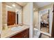 Bathroom with decorative mirror, classic vanity, and adjacent toilet room at 3080 Big Bear Dr, Sedalia, CO 80135