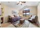Cozy bedroom with vaulted ceiling, scenic window view, and comfortable sitting area at 3080 Big Bear Dr, Sedalia, CO 80135