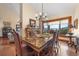 Open dining area with a marble table, chandelier lighting, and natural light from the large windows at 3080 Big Bear Dr, Sedalia, CO 80135