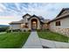 Stunning home with stone accents, manicured lawn, and welcoming entrance at 3080 Big Bear Dr, Sedalia, CO 80135