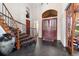 Grand foyer with a curved staircase and double door entrance at 3080 Big Bear Dr, Sedalia, CO 80135