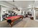 Entertainment room with a pool table, bar seating, and an adjacent sitting area at 3080 Big Bear Dr, Sedalia, CO 80135