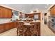 Well-equipped kitchen featuring a large island with seating, stainless steel appliances, and custom wood cabinetry at 3080 Big Bear Dr, Sedalia, CO 80135