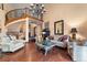 Spacious living room with staircase, hardwood floors, and lots of seating at 3080 Big Bear Dr, Sedalia, CO 80135