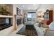 Cozy living room with fireplace, deck access, and comfortable seating at 3080 Big Bear Dr, Sedalia, CO 80135