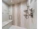 Modern shower includes a built-in bench and shelving with decorative tile accents at 3080 Big Bear Dr, Sedalia, CO 80135