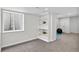 Finished basement area featuring shelving, carpet, and a small window at 1920 E 145Th Ave, Thornton, CO 80602