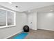 Basement room featuring a blue yoga mat, gym ball and a small window at 1920 E 145Th Ave, Thornton, CO 80602
