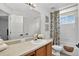 Bathroom with a wooden vanity, white walls, and a shower/tub combination with floral curtains at 1920 E 145Th Ave, Thornton, CO 80602
